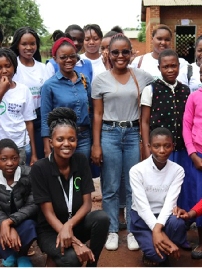 green girls platform tree planting exercise with students