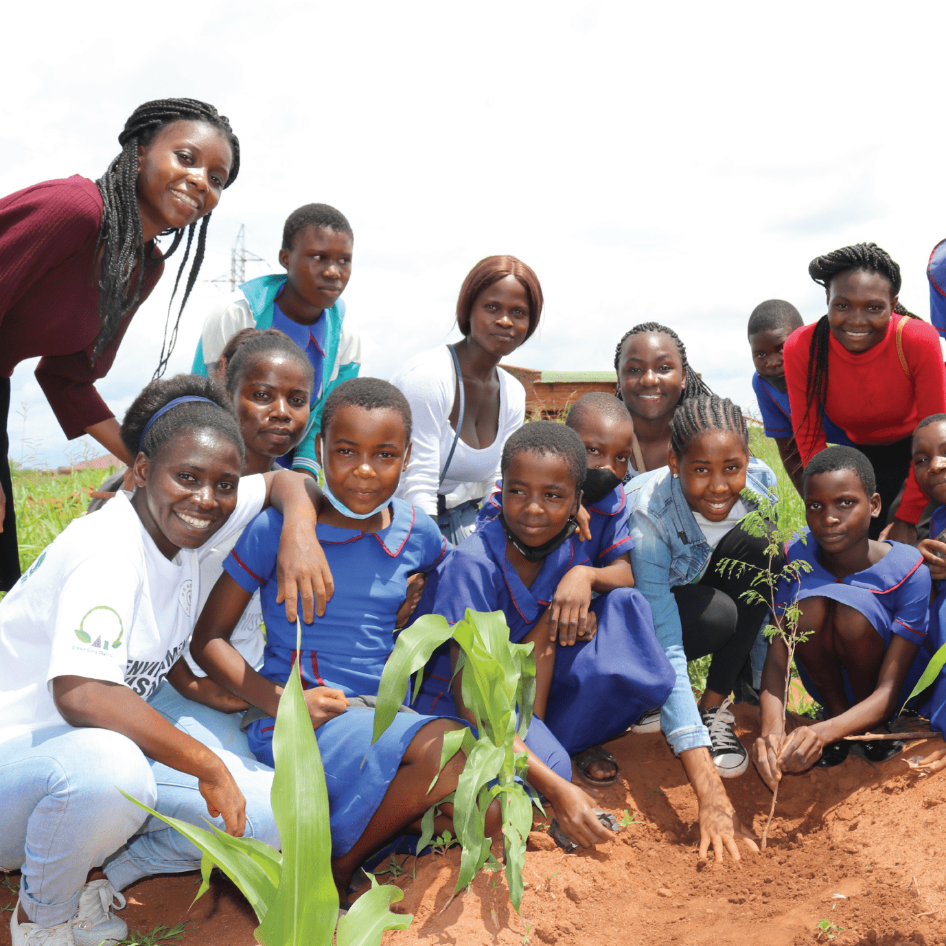 green girls platform tree planting exercise with students